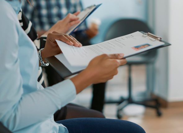 female-candidate-sitting-queue-receiving-cv-files