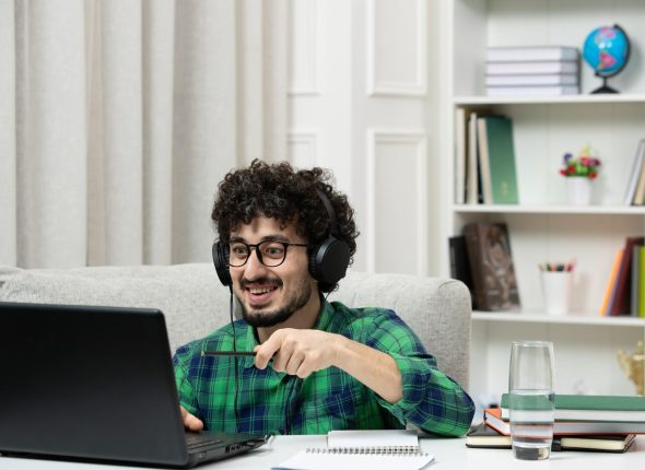 student-online-cute-young-guy-studying-computer-glasses-green-shirt-looking-happy_140725-164633