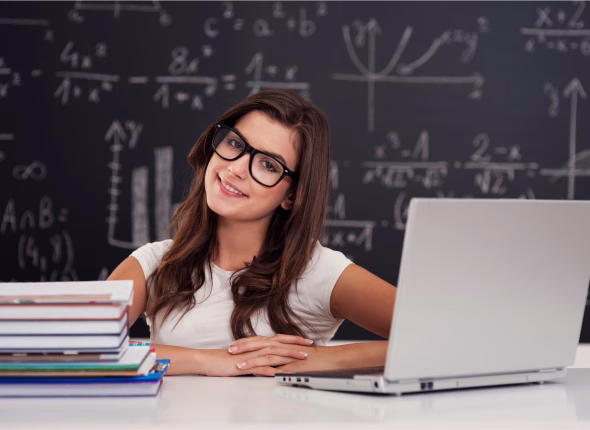 Female maths tutor holding a laptop with a chalkboard behind her, offering online mathematics classes for Grade 7 to 12 students at Apex Academic Centre.