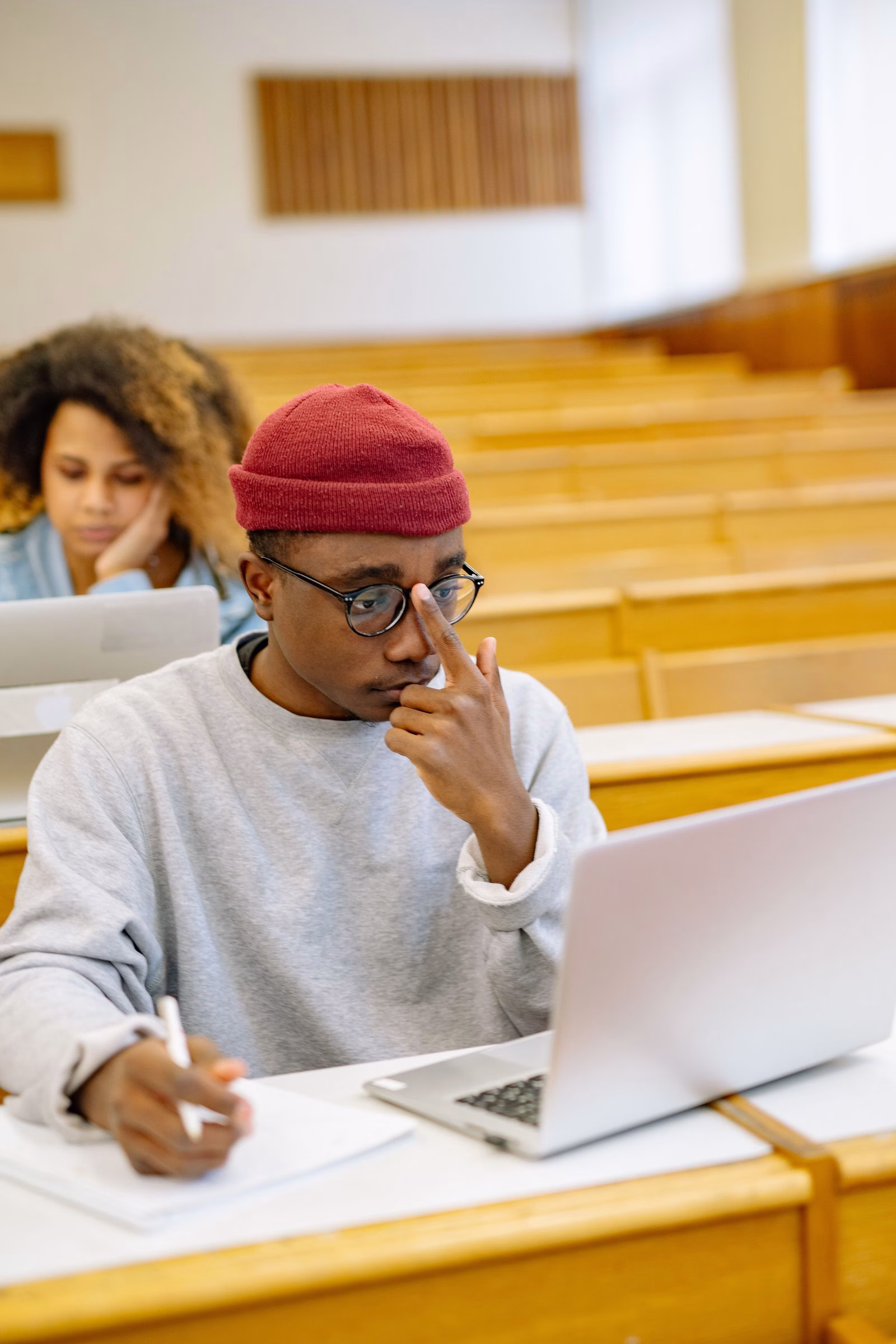 South African Pearson Edexcel student studying in a lecture hall with a laptop