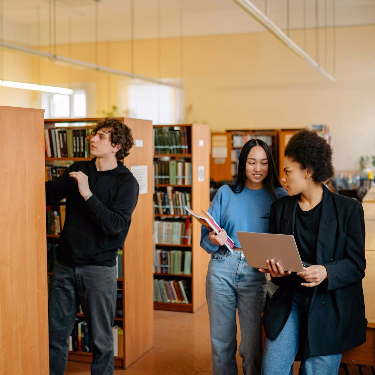 University-bound students collaborating on Pearson Edexcel International A Level coursework in a library