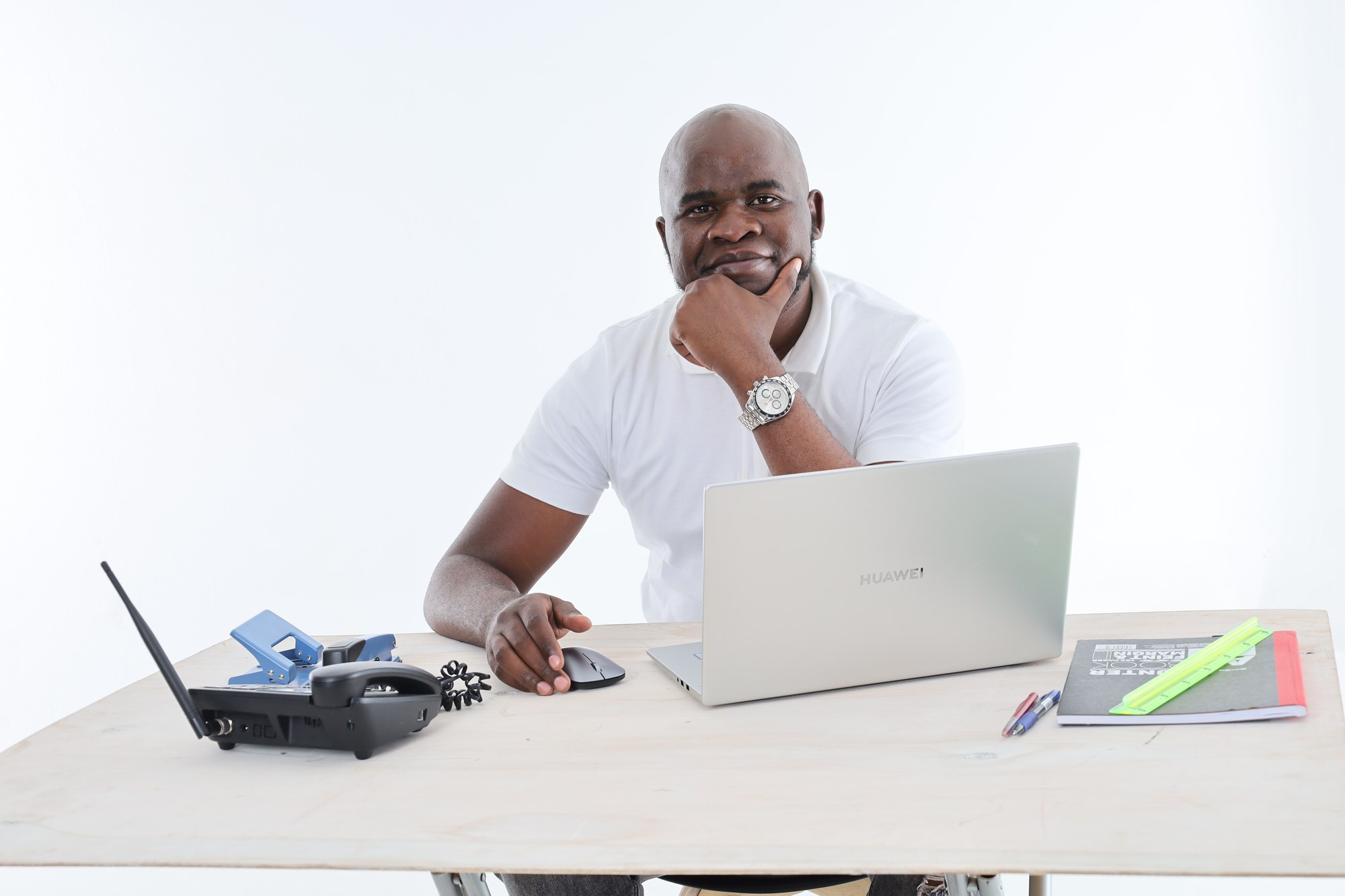 A South African Apex Academic Centre tutor sitting at his desk with a laptop, ready to start an online lesson