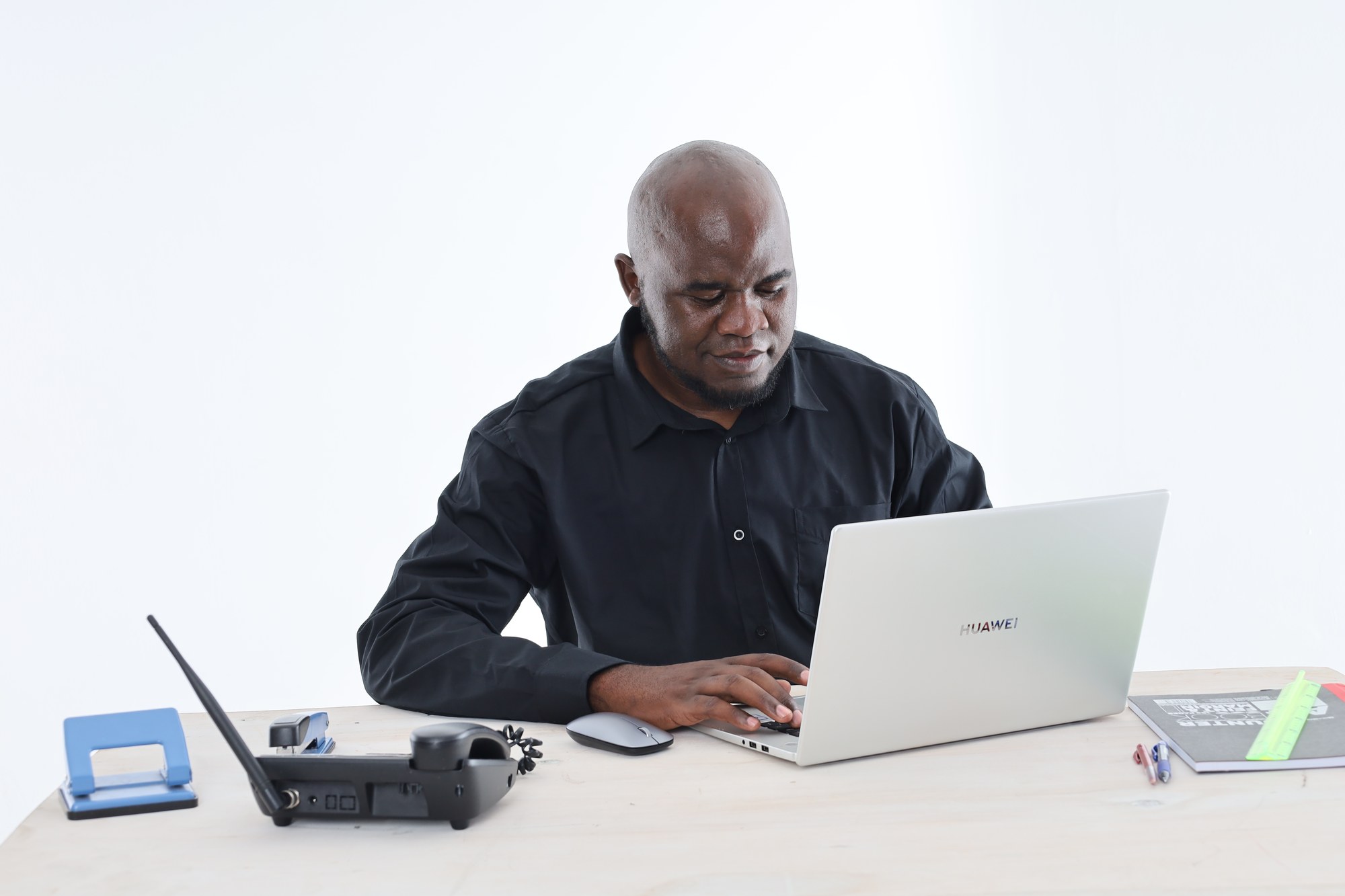 An Apex Academic Centre tutor working at a laptop while preparing a lesson