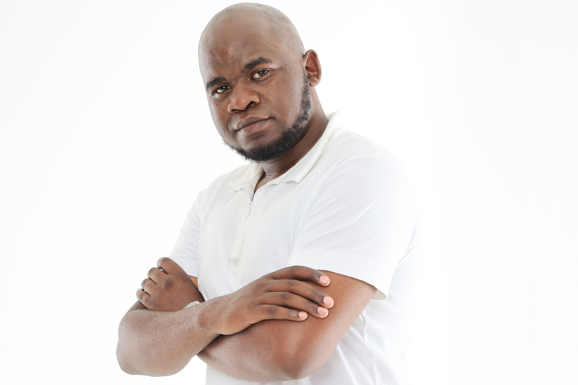 A South African Apex Academic Centre tutor standing with his arms folded
