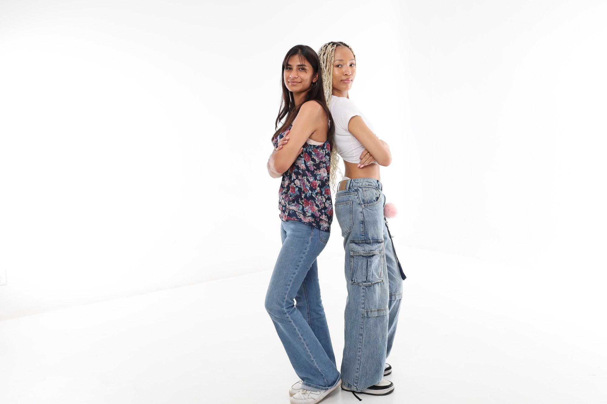 Two South African learners standing back to back and smiling at the camera